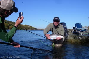 Justin Crump snaps a photo of Bob's final chrome Naknek rainbow that smoked line off of his reel.