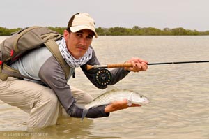 Mike Visintainer doing his patent Bonefish palming pose for the camera.