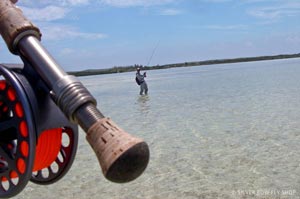 Sean's reel is getting line pulled out by a Bonefish while Mike fights his fish off in the distance.