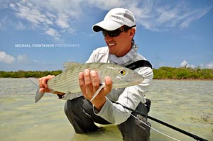 Sean Visintainer looking at a nice bonefish he caught before releasing back to the flat.