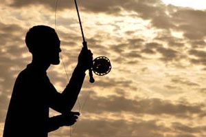 Mike Visintainer casting for baby Tarpon and Ladyfish in the last moments of light.