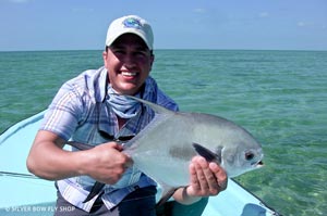 Sean Visintainer holding his first Permit landed on his hosted trip to Belize... first one landed btw... not the first one hooked!
