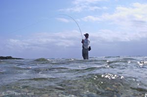 6 foot 7 inch Josh Mills towers above the flat as he fights a nice San Pedro Bonefish.
