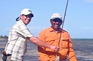 Sean Visintainer and guide Omar acting their age as they walk the flats on the reef side of San Pedro, Belize.