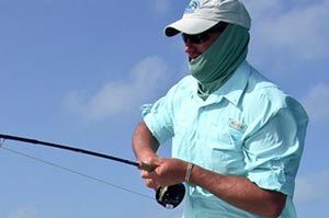 Doug Brady of Fly Treks hoists a hefty permit from the depths of Belize in the Tres Pescado Tournament.