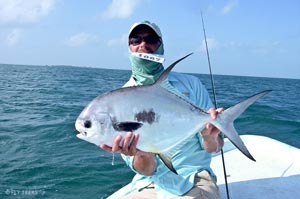 Doug Brady holds one of multiple permit he caught for Team Flytreks in San Pedro Belize.