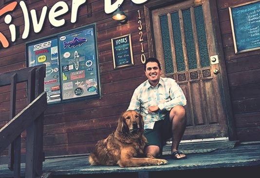 Sean Visintainer with his dog Ed outside the Silver Bow Fly Shop, Spokane