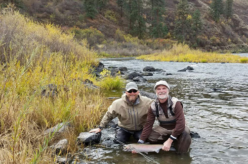 Steelhead Guide Travis with client after landing a hatchery steelhead.