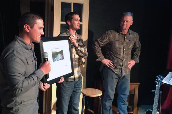 Sean Visintainer, left, and Michael Visintainer, center, of Silver Bow Fly Shop in Spokane Valley are honored by the Spokane Riverkeeper for conservation service to the river.