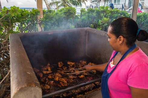 Turneffe Lodge cook grilling up a chicken feast. 