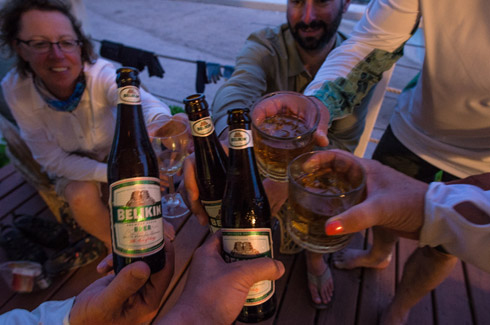 Guests at Turneffe Lodge enjoying cold beverages on the deck. 