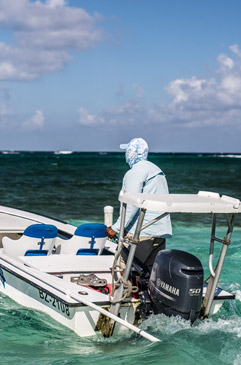 Mark Hyde running the skiff back at the end of the day at Turneffe Flats Lodge.