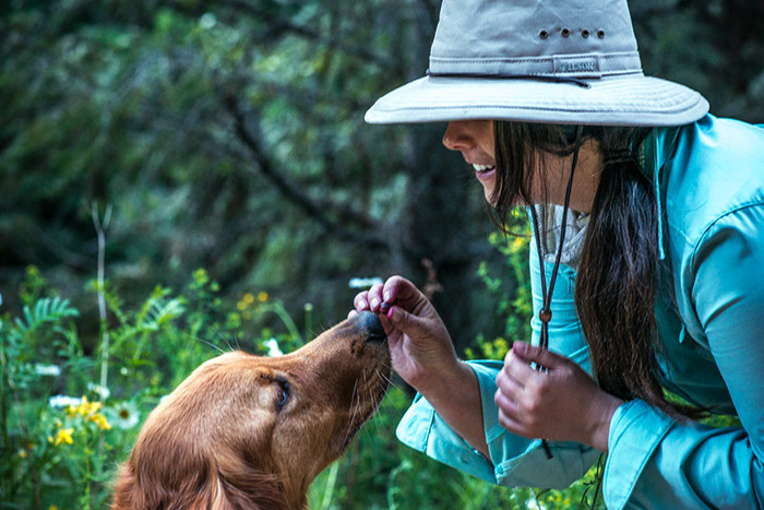 Feeding the dog huckleberries from the Coeur d'Alene River, Idaho.