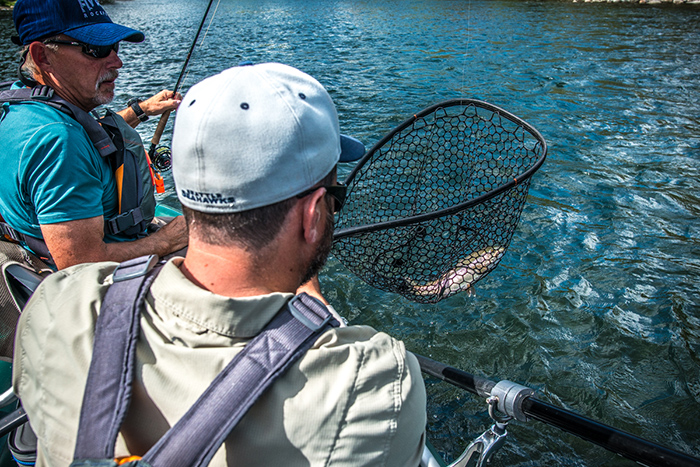 Bo Brand and Mark Russell netting a Spokane River Redband while fly fishing.
