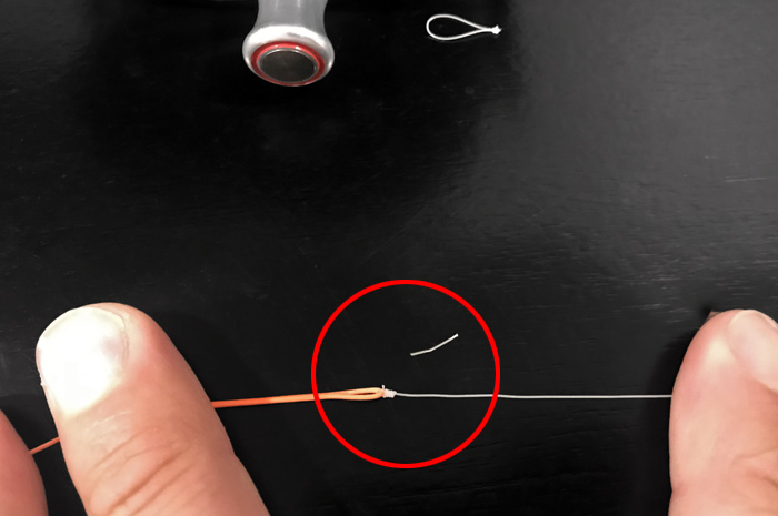 Trim the excess tag of the clinch so the knot travels smoothly through the guides.