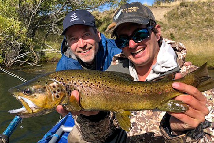 Las Pampas all star guide Tim Watters and our friend Mark S. with a great brown trout from the Rio Pico.