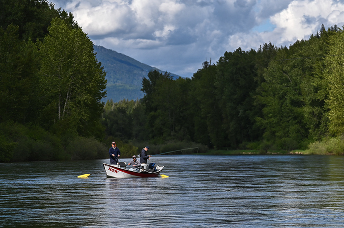 Fly fishing guide Michael Laughlin (ROW Adventures) navigates down the NF Coeur d'Alene River while guiding cutthroat trout.