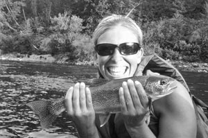 It's all smiles for Heather with one of numerous rainbows from the Spokane River.
