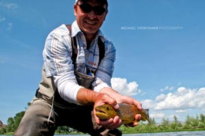 Uncle Ben sporting the Simms Waders and shirt with a Montana Brown Trout.